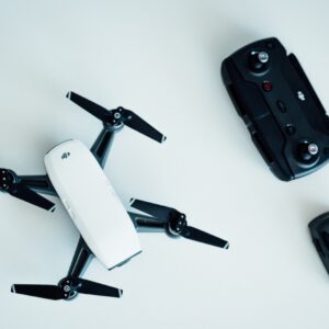 white and black quadcopter drone on white table